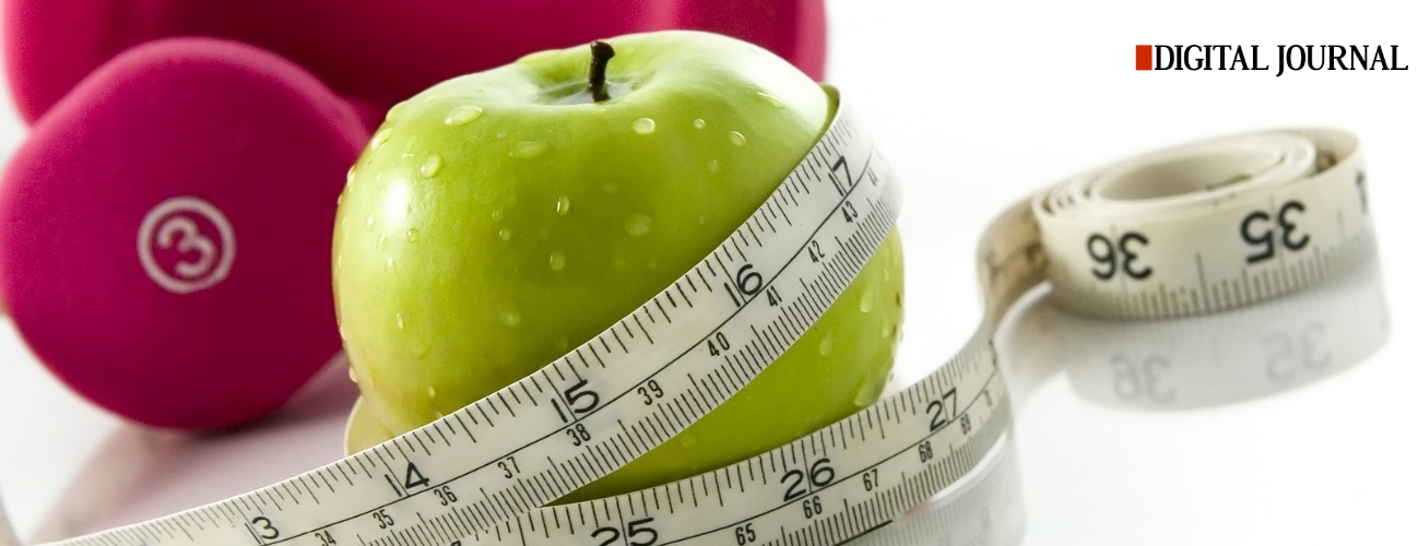 Image of a green apple with a measuring tape wrapped around it and a set of hand weights.